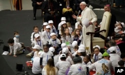 Pope Francis is surrounded by children as he speaks with patients and caregivers from the Vatican's Bambino Gesu Pediatric Hospital, Dec. 15, 2016.
