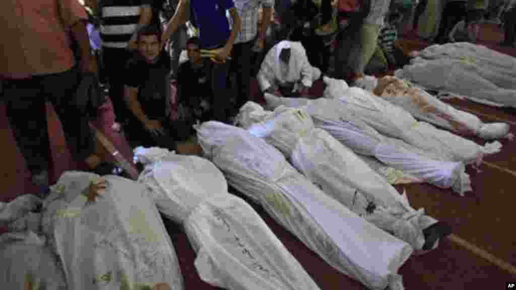 Egyptians mourn over the bodies of their relatives in the El-Iman mosque, Thursday, Aug. 15, 2013.