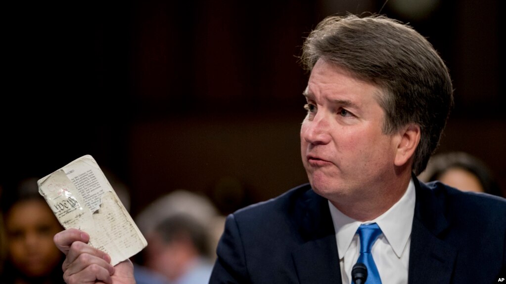 Supreme Court nominee Brett Kavanaugh, a federal appeals court judge, holds up a worn copy of the Constitution of the United States as he testifies before the Senate Judiciary Committee on Capitol Hill in Washington, Sept. 5, 2018.