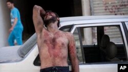 A Syrian man cries outside the Dar El Shifa hospital in Aleppo, Syria after his daughter was injured during a Syrian Air Force strike over a school where hundreds of refugees had taken shelter Thursday, Oct. 4, 2012.