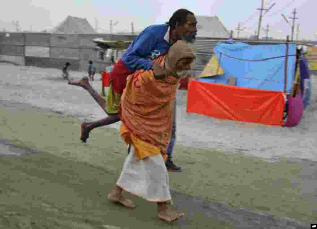 A "Sadhu" or Hindu holyman carries a handicap Sadhu during Magh Mela, in the northern Indian city of Allahabad January 12, 2012.