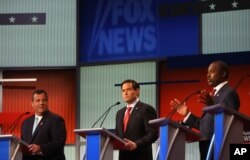 Chris Christie, Marco Rubio and Ben Carson take the stage for the first Republican presidential debate, Cleveland, IN, Aug. 6, 2015.