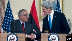 Libyan Prime Minister Ali Zdidan, shown here shaking hands with U.S. Secretary of State John Kerry March 13, 2013, is under pressure to stop the crippling oil industry strikes.