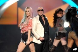 Ke$ha, left, and Pitbull perform at the American Music Awards at the Nokia Theatre L.A. Live on Nov. 24, 2013, in Los Angeles.