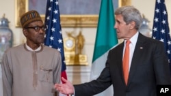 Secretary of State John Kerry gestures while he and Nigerian President Muhammadu Buhari make statements prior to a working lunch at the State Department in Washington, July 21, 2015. 