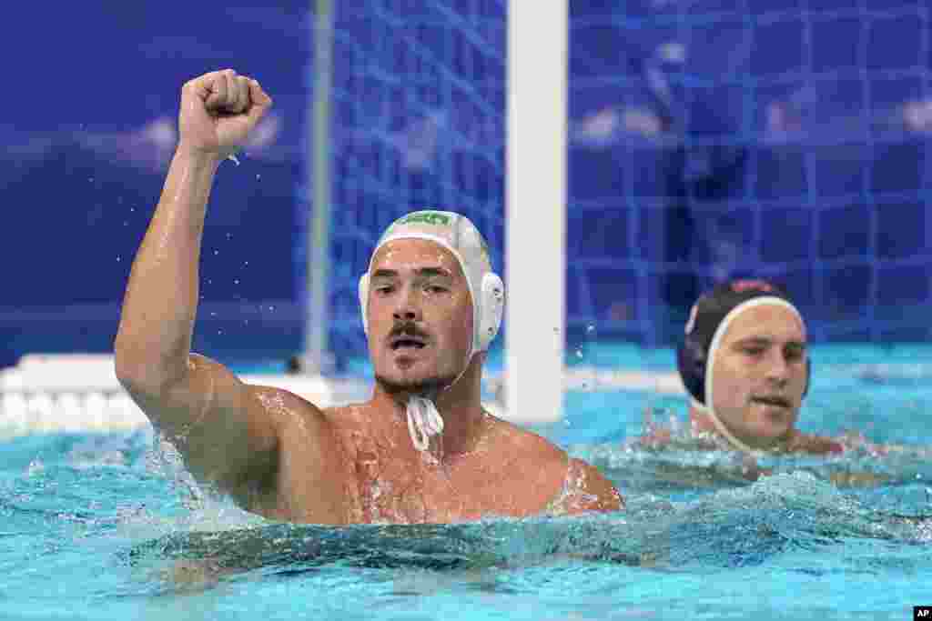 South Africa&#39;s Nardus Badenhorst, left, celebrates after scoring against the United States during a preliminary round men&#39;s water polo match at the 2020 Summer Olympics, Tuesday, July 27, 2021, in Tokyo, Japan. (AP Photo/Mark Humphrey)