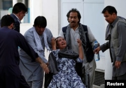 An Afghan woman mourns at the hospital after a blast in Kabul, Afghanistan, July 15, 2018.