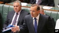 Australia's Prime Minister Tony Abbott speaks about the nation's new anti-extremism strategy during a question time at Parliament House in Canberra, Australia, Feb. 23, 2015. 