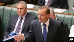 FILE - Australia's Prime Minister Tony Abbott speaks about the nation's new anti-extremism strategy during a question time at Parliament House in Canberra, Australia, Feb. 23, 2015. 