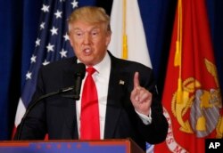 FILE - Then-presidential candidate Donald Trump gestures during a speech in Virginia Beach, Virginia, July 11, 2016.