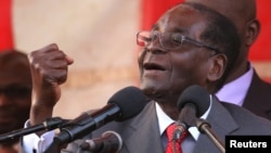 FILE - Zimbabwe President Robert Mugabe gestures as he addresses supporters of his ruling ZANU-PF party at Harare International Airport, Zimbabwe, Sept. 24, 2016. 