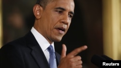 U.S. President Barack Obama gestures while addressing his first news conference since his re-election, at the White House in Washington, November 14, 2012. 