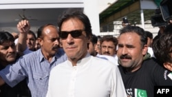 FILE - Pakistan opposition leader and head of the Pakistan Tehreek-e-Insaf (PTI, Pakistan Movement for Justice) political party Imran Khan leaves Parliament after attending a session in Islamabad, May 23, 2018.