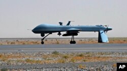 FILE - U.S. Predator unmanned drone armed with a missile stands on the tarmac of Kandahar military airport in Afghanistan. 