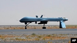 FILE - An unmanned U.S. Predator drone armed with a missile is seen standing on the tarmac.