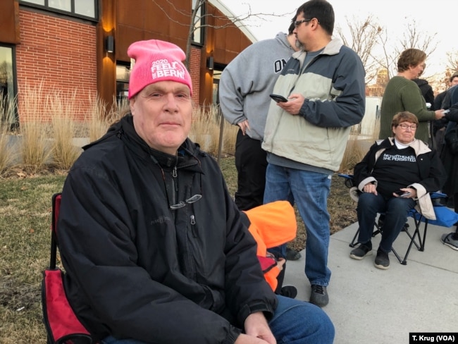 Ed Hotchkin voted for Hillary Clinton in the 2016 election, but he is eyeing Senators Bernie Sanders and Elizabeth Warren this time. He attended the Warren rally in Des Moines, Jan. 5, 2019, in a pink "2010 Feel The Bern! hat.