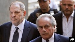 Harvey Weinstein, left, arrives to court in New York, June 5, 2018. Weinstein pleaded not guilty Tuesday to rape and criminal sex act charges. 