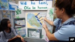 Maleka Benjamin, 9, of Honolulu, listens to her 3rd grade kumu (teacher) Nakoolani Warrington at Kikula Kaipuni o Anueanue, a public Hawaiian immersion school in Honolulu, March 9, 2005. (AP PHOTO/Lucy Pemoni)