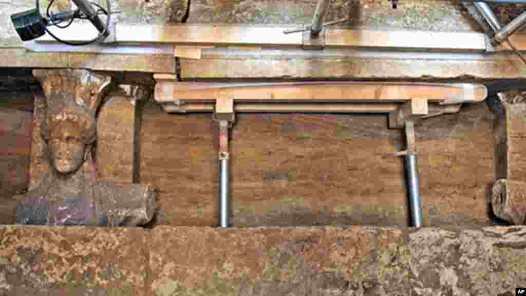 In a photo released Sunday, 60 centimeter (2 foot) female figurines are shown on a wall leading to the yet unexplored main room of an ancient tomb, in the town of Amphipolis, northern Greece, Sept. 7, 2014.