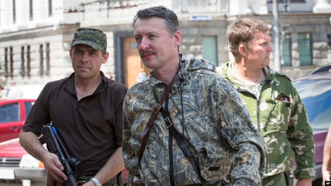 FILE - Igor Girkin, center, arrives for the wedding of platoon commander in Donetsk, Ukraine, July 11, 2014.