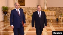 Libyan military commander Khalifa Haftar walks with Egyptian President Abdel Fattah el-Sissi at the Presidential Palace in Cairo, Apr. 14, 2019 in this handout picture courtesy of the Egyptian Presidency. 