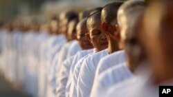 FILE-Hundreds of Buddhist nuns wait in line at the Royal Palace to pay their respects to the late former Cambodian King Norodom Sihanouk in Phnom Penh, Saturday, Feb. 2, 2013. 