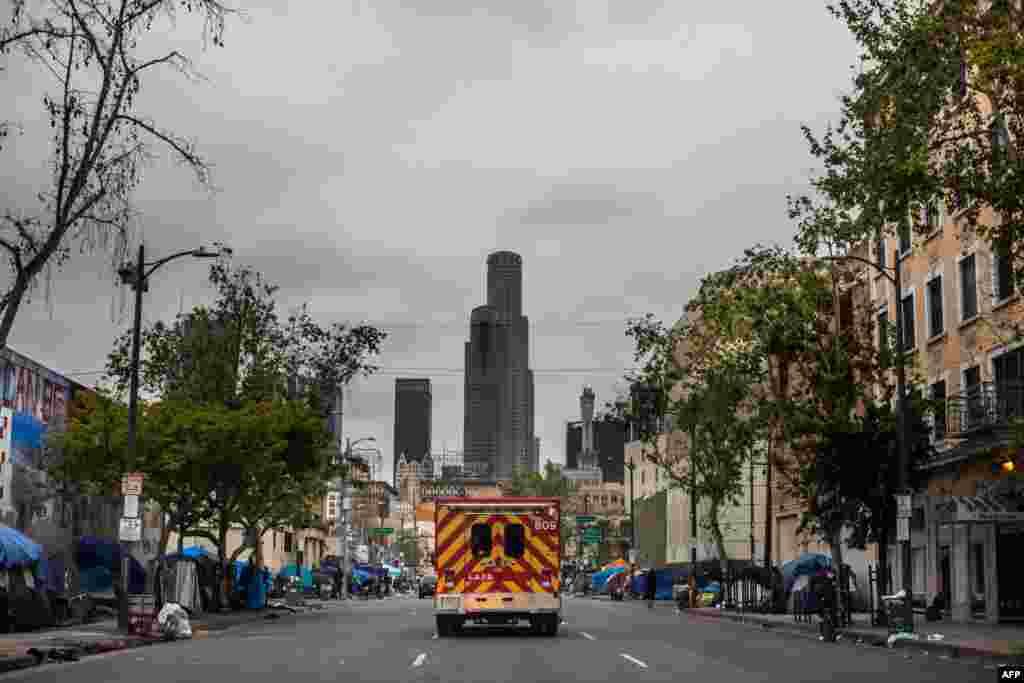 An ambulance of the LAFD Station No9 rides at Skid Row in downtown Los Angeles, California, April 12, 2020.