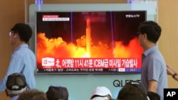 FILE - People watch a TV news program showing an image of North Korea's latest test launch of an intercontinental ballistic missile (ICBM), at the Seoul Railway Station in Seoul, South Korea, July 29, 2017.