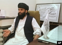 FILE - Suhail Shaheen, then-deputy ambassador of the Islamic Republic of Afghanistan, gives an interview in Islamabad, Pakistan, Nov. 14, 2001.