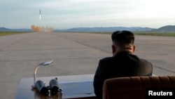 FILE - North Korean leader Kim Jong Un watches the launch of a Hwasong-12 missile in this undated photo released by North Korea's Korean Central News Agency (KCNA).