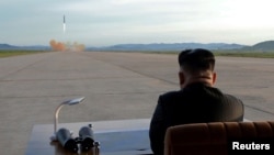 FILE - North Korean leader Kim Jong Un watches the launch of a Hwasong-12 missile in this undated photo released by North Korea's Korean Central News Agency (KCNA).