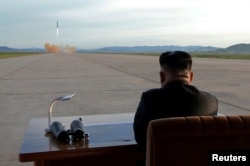 FILE - North Korean leader Kim Jong Un watches the launch of a Hwasong-12 missile in this undated photo released by North Korea's Korean Central News Agency (KCNA), Sept. 16, 2017.