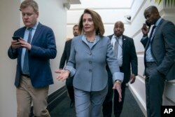 FILE - House Speaker Nancy Pelosi, D-Calif., walks to a Democratic caucus meeting at the Capitol in Washington, March 26, 2019.