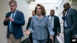 FILE - House Speaker Nancy Pelosi, D-California, walks to a Democratic Caucus meeting at the Capitol in Washington, March 26, 2019. 