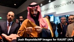 Saudi Crown Prince Mohammed bin Salman observes a showing of Saudi Arabian technology, including an exhibit by King Abdullah University of Science and Technology, during a visit to Massachusetts Institute of Technology on Saturday, March 24, 2018.