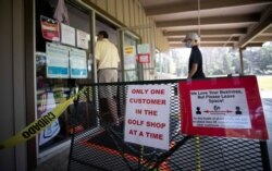 Social distancing signs are pictured at Eaton Canyon Golf Course, which re-opened today, during the outbreak of the coronavirus disease (COVID-19), in Pasadena, California, U.S., May 9, 2020.