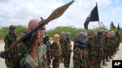 Al-Shabab fighters display weapons as they conduct military exercises in northern Mogadishu, Somalia, Oct. 21, 2010 file photo.