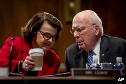 Sen. Dianne Feinstein, D-Calif., talks to Sen. Patrick Leahy, D-Vt., on Capitol Hill in Washington during the Senate Judiciary Committee's business meeting to discuss the nomination of Attorney General-designate Sen. Jeff Sessions, R-Ala., Jan. 31, 2017.