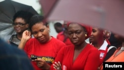 FILE - Activists attend a "Bring Back Our Girls" rally to pressure Nigeria's government to find schoolgirls abducted in April, Lagos, July 5, 2014.