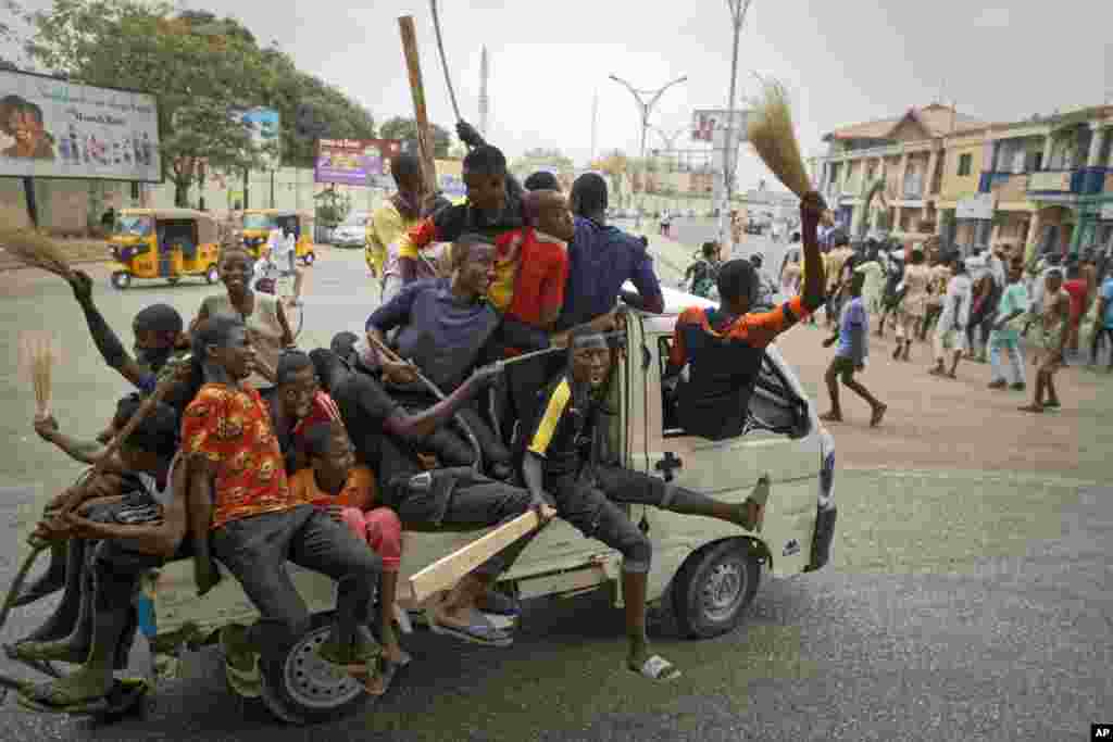 Supporters of Nigeria's President Muhammadu Buhari celebrate his electoral win, on a street in Kano, Nigeria.