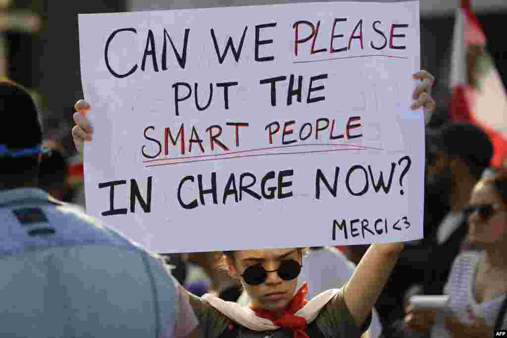 Lebanese protesters rally in downtown Beirut during ongoing demonstrations to demand better living conditions and the ouster of politicians who have monopolized power and influence for decades.