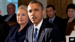 This Nov. 28, 2012 file photo shows then-Secretary of State Hillary Rodham Clinton listening as President Barack Obama speaks in the Cabinet Room at the White House in Washington. (AP Photo/Jacquelyn Martin, File)
