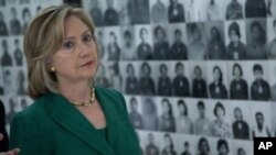 U.S. Secretary of State Hillary Rodham Clinton looks at a wall of faces of those killed by the Khmer Rouge regime, during a tour of the Tuol Sleng Genocide Museum, formerly the regime's notorious S-21 prison, on Monday, Nov. 1, 2010, in Phnom Penh, Cambo