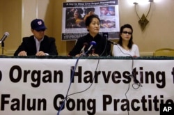 FILE - Dr. Wenyi Wang (C) holds a press conference with others, who preferred not to be identified, in Arlington, Virginia, April 26, 2006, about her having interrupted Chinese President Hu during his speech at the White House in Washington. Wang said she interrupted Hu to bring global attention to the organ harvesting from living Falun Gong practitioners in China.