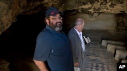 Yehuda Shaul, front, co-founder of Breaking The Silence, and Irish author Colm Toibin visit Susiya archaeological park, south of Hebron, West Bank, July 12, 2016.
