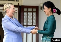 FILE - Pro-democracy leader Aung San Suu Kyi Clinton after meeting at Suu Kyi's residence in Rangoon, Burma, December 2, 2011.