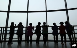 Visitors watch the North Korea side from the unification observatory in Paju, South Korea, April 25, 2017.