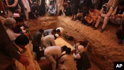Afghans bury the bodies of victims of the Dubai City wedding hall bombing during a mass funeral in Kabul, Afghanistan, Sunday, Aug.18, 2019. (AP Photo/Rafiq Maqbool)