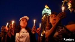 FILE - People attend a candlelight vigil for people missing after a boat carrying migrants from Tunisia sank off the southern Italian island of Lampedusa, September 2012, in Tunis September 10, 2012.