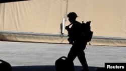 FILE - A U.S. soldier is seen during a handover ceremony of Taji military base from U.S.-led coalition troops to Iraqi security forces, in the base north of Baghdad, Iraq, Aug. 23, 2020. 